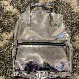 Limited edition shiny silver Disney backpack. NEVER USED